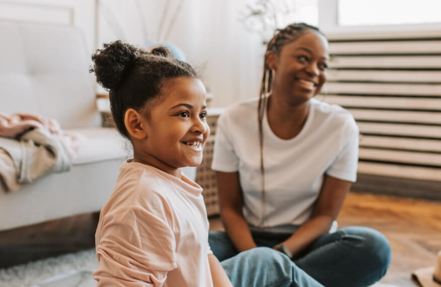 Mother and daughter sitting on the floor