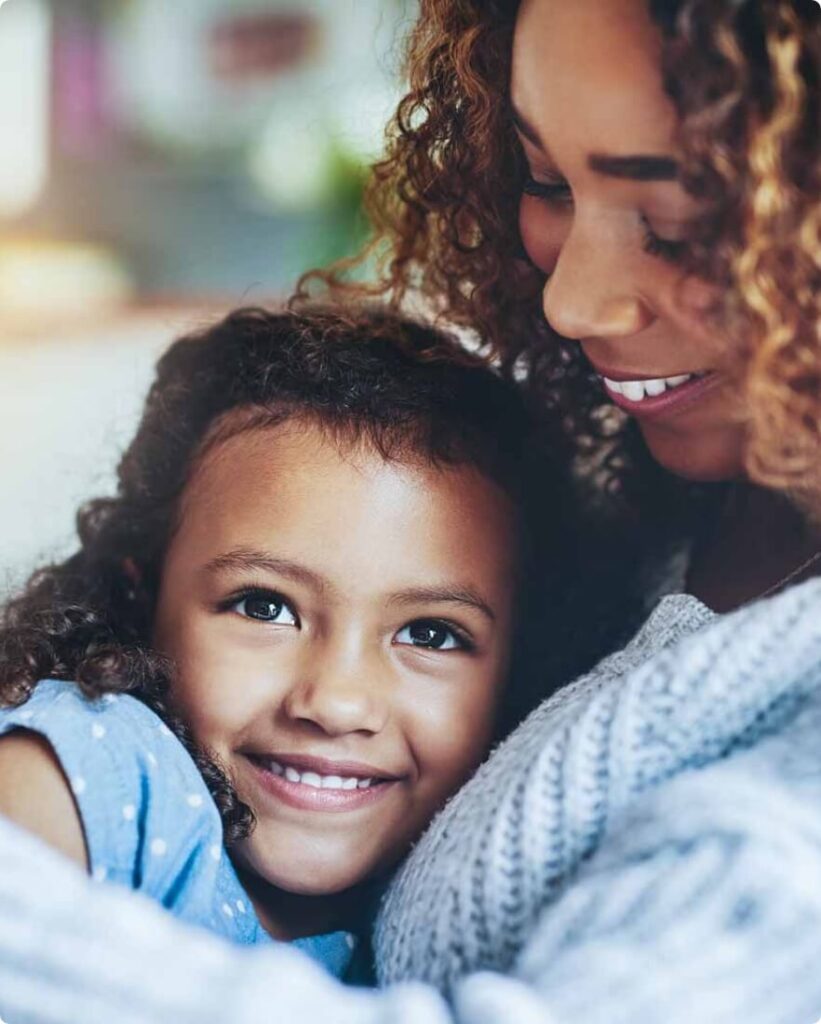 Mother and daughter embracing and smiling