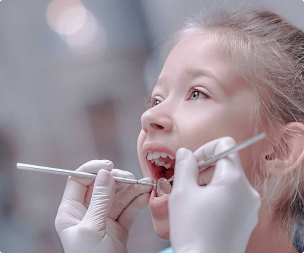 Child having teeth examined