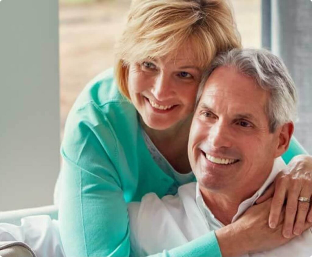 Older couple embracing and smiling